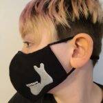 A girl wearing a Build Your Face Mask with a star on it.