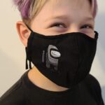 A boy wearing a Build Your Face Mask with a Star Wars design.