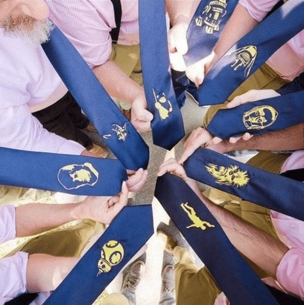 A group of men holding Custom Wedding Ties in a circle.