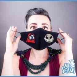 A woman wearing the Nightmare Before Christmas Face Mask featuring Jack and Sally.