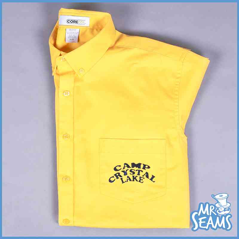 An eye-catching Camp Crystal Lake shirt in vibrant yellow, proudly displaying the iconic words "Camp Crystal Line" on its front.