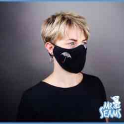 A woman wearing an Umbrella Academy Face Mask.