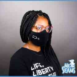 A woman wearing the Equality Is Greater Than Division Face Mask.