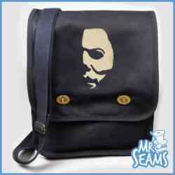 A black messenger bag with a mr seams face on it.
