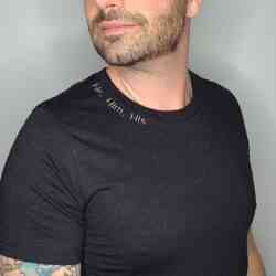 The SubtleT Build Your Own man, with tattoos, wearing a black t-shirt.