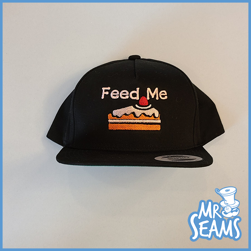 A Cake Hat, Beanie, Mask that says feed me.