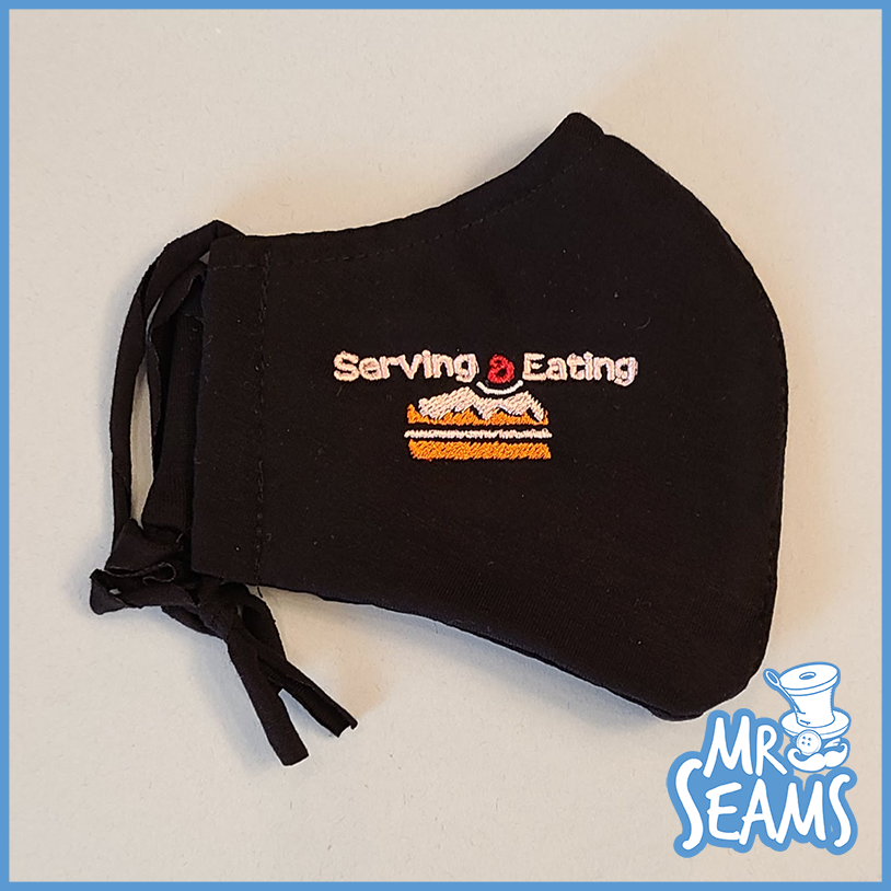 A black Cake Hats, Beanies, Masks with the words serving and eating on it.