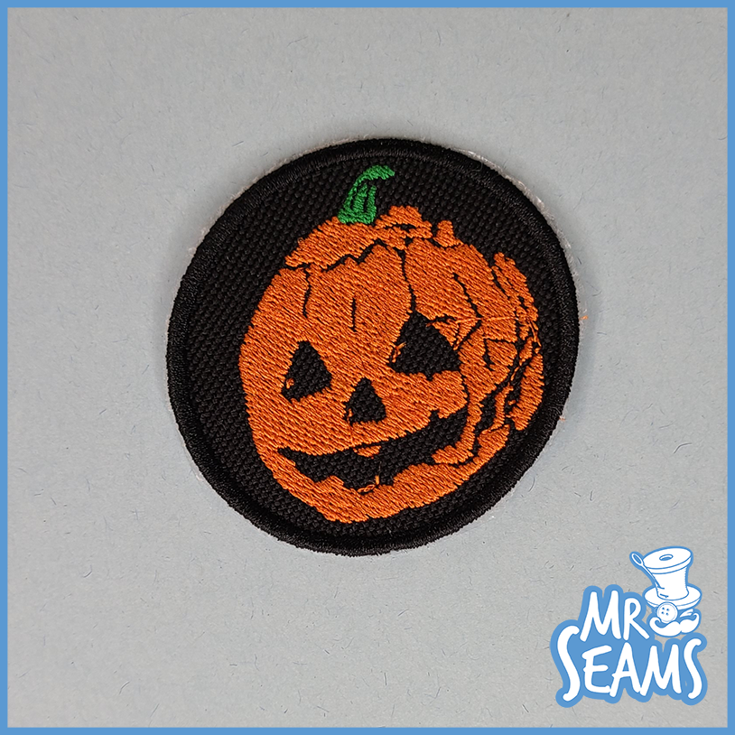 A patch with a jack o lantern on it.