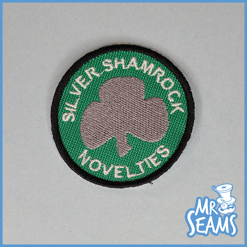 Silver shamrock novelties patch.