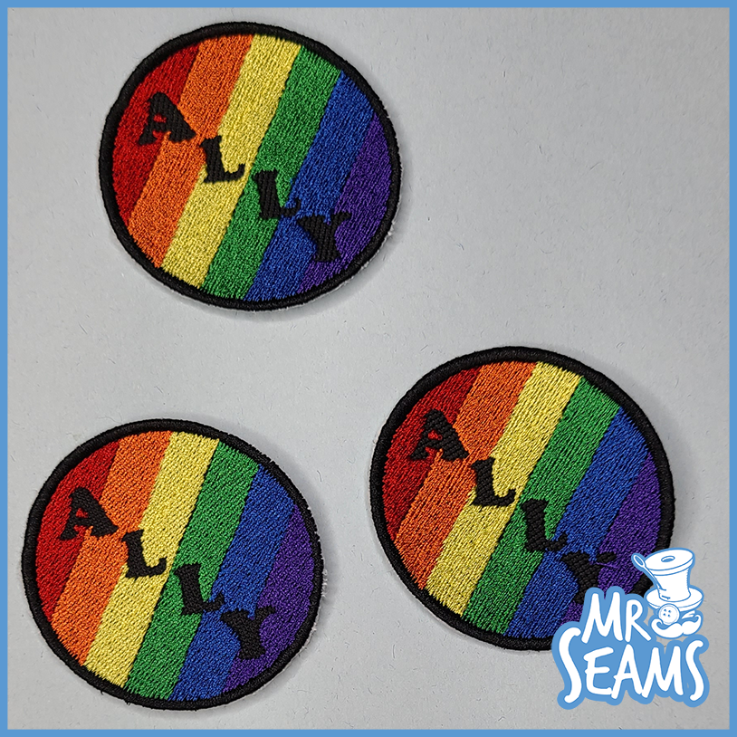 Three Pride Triangle Patches with the words mr mrs mrs mrs mrs mr.