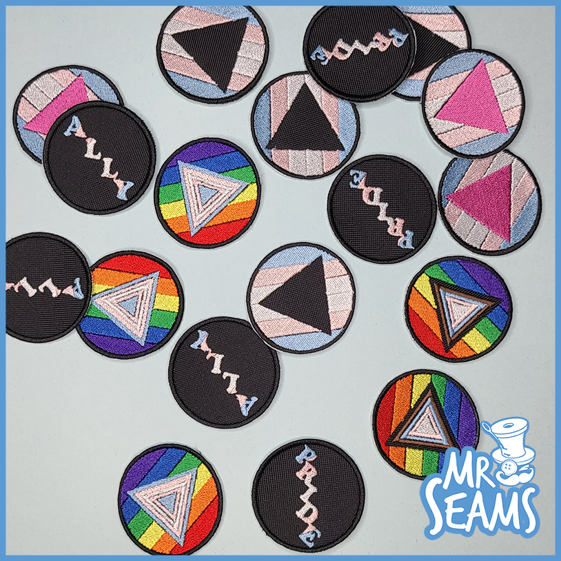 Mr. Seams Pride Triangle Patches feature rainbow triangles.