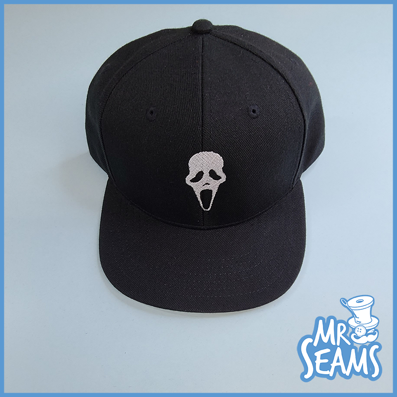 A black snapback hat with a skull and crossbones on it from the Star Trek Beanies & Hats collection.