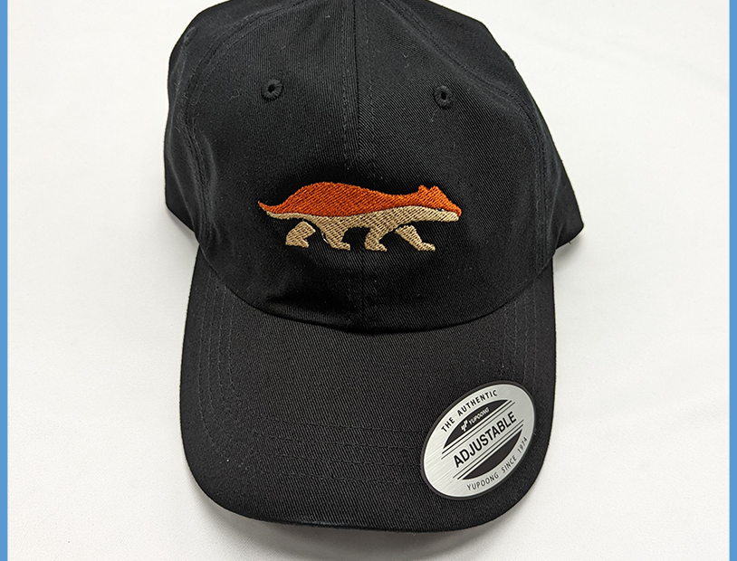 A black hat with DJ Industrial Badger Hats & Beanies embroidered on it.