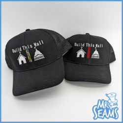 Two Build This Wall Hats & Beanies with the slogan "build this wall" and an embroidered graphic of a brick wall.