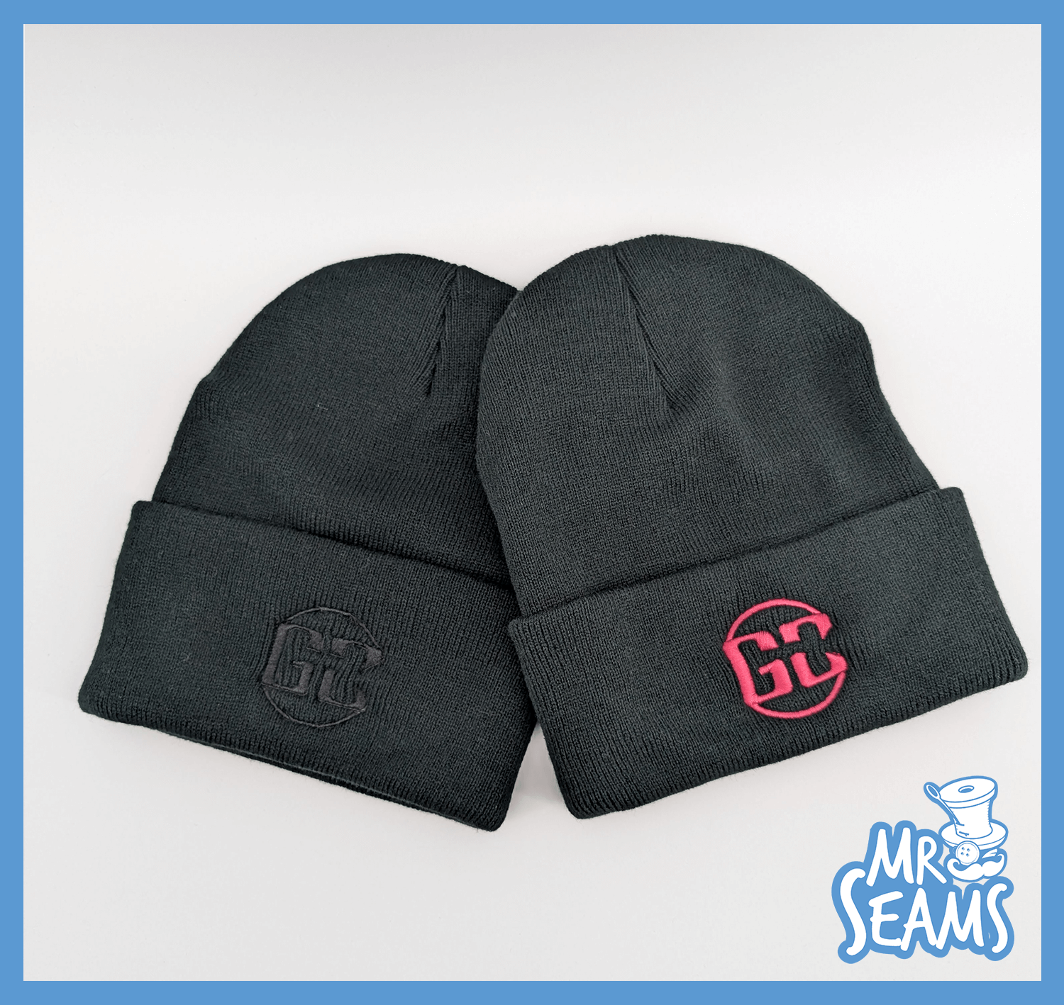 Two black beanies with embroidered logos.