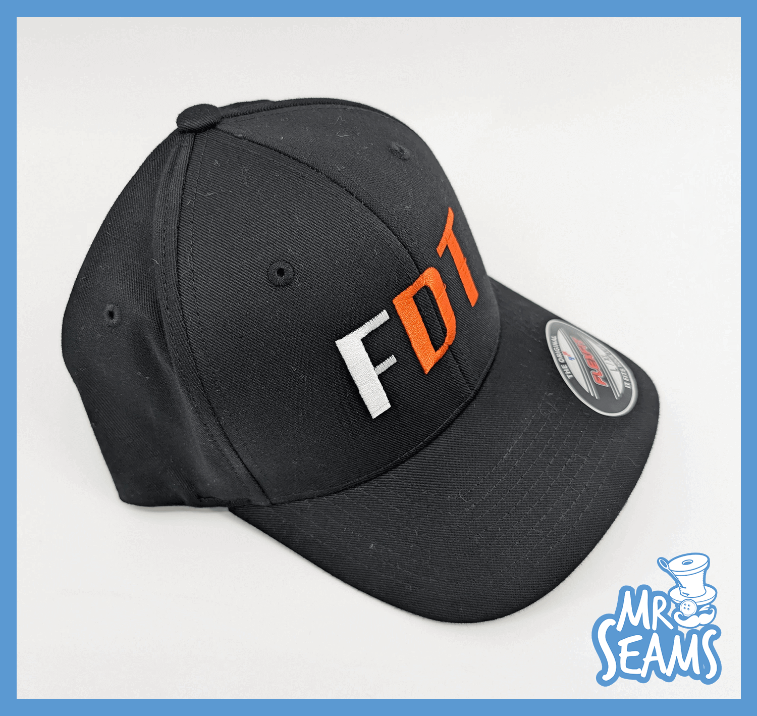 Black cap with "FDT" embroidered in orange.