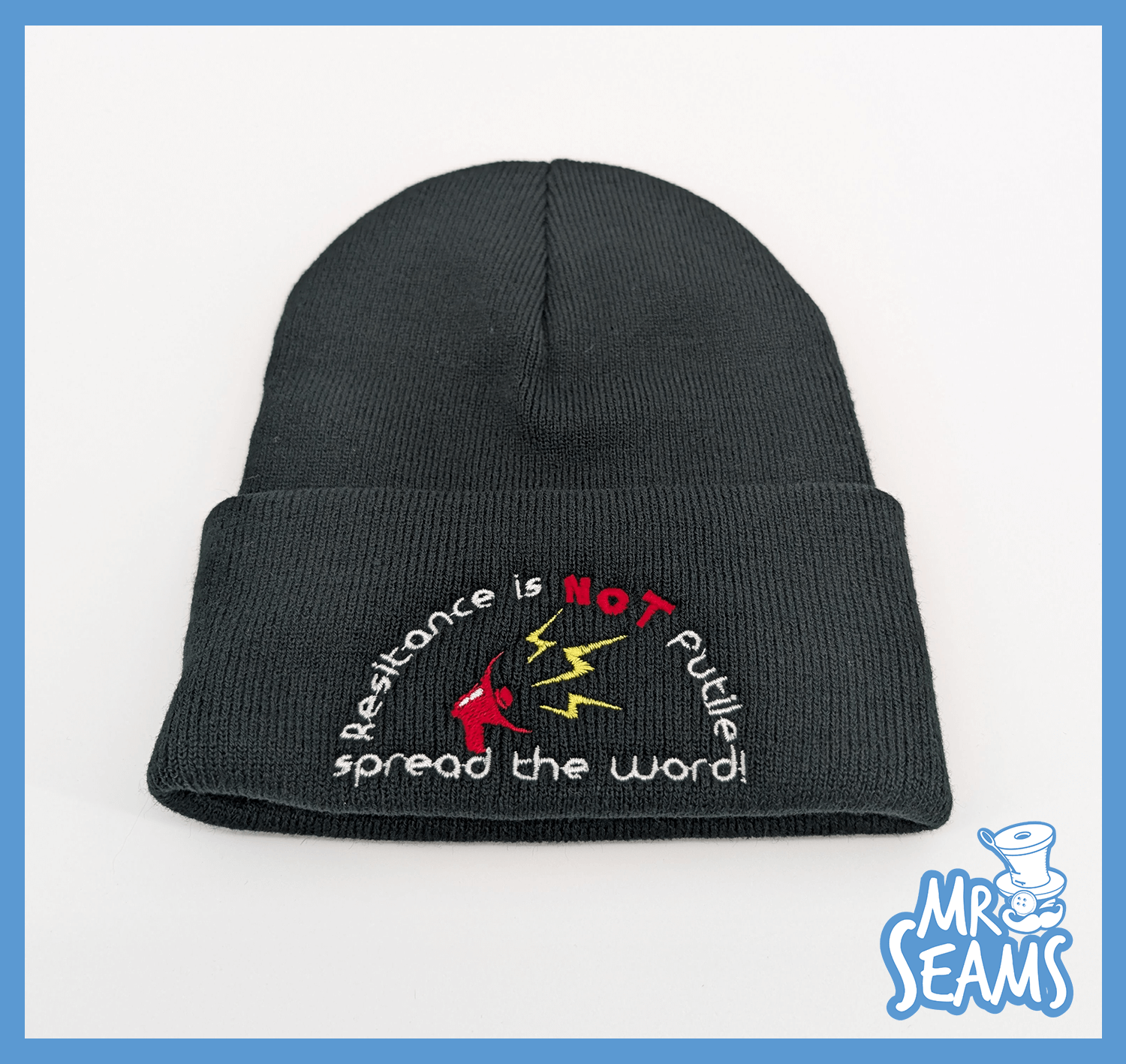 Black beanie with embroidered resistance slogan.
